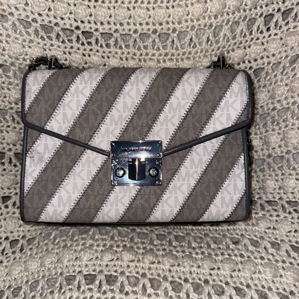 Michael Kors Grey and White Striped Crossbody Bag with silver hardware.